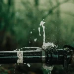 Water spraying from a leaking pipe joint